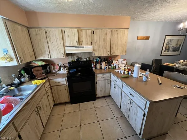 a kitchen with a sink a stove and cabinets