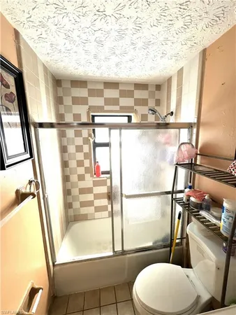 a bathroom with a toilet mirror and a sink