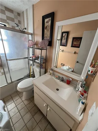 a bathroom with a sink mirror vanity and toilet