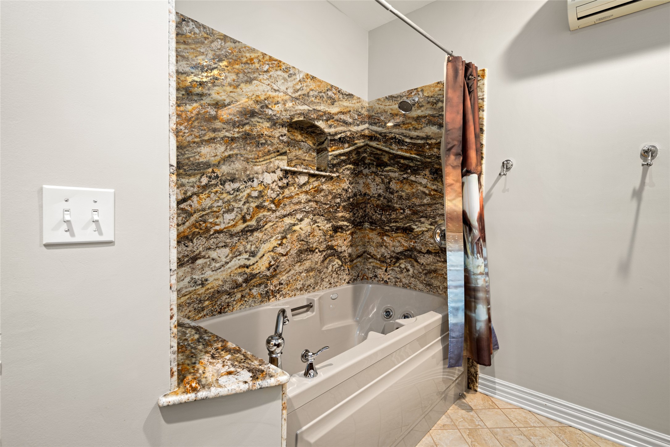15126 Walden Road Montgomery, TX 77356 - Photo 46 of 50 This bathroom features exotic granite on the walls and a jacuzzi bathtub.