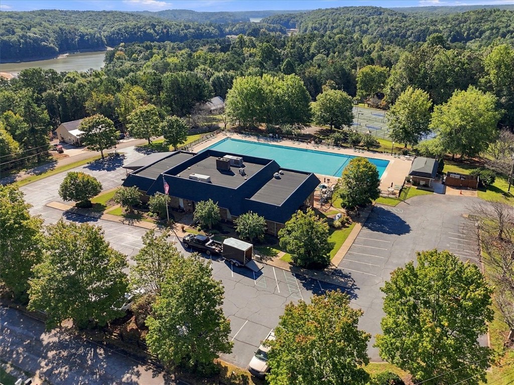 211 Cedar Ridge Drive Westminster, SC 29693 - Photo 33 of 34 Lush forested hills surround the community swimming pool and tennis courts in this aerial view.