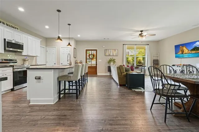 a view of a dining room with furniture kitchen and wooden floor