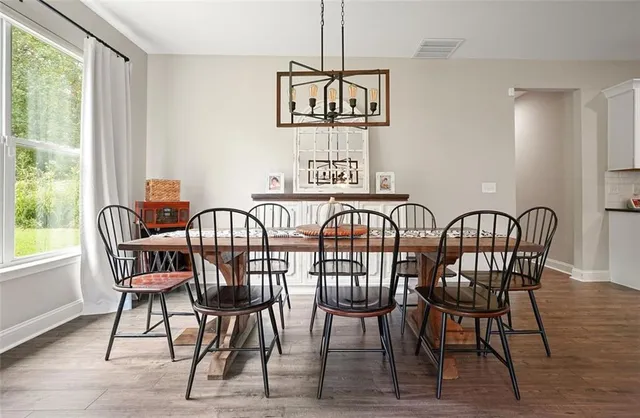 a view of a dining room with furniture window and wooden floor