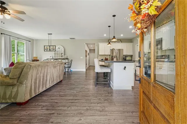 a large kitchen with stainless steel appliances granite countertop a stove and cabinets