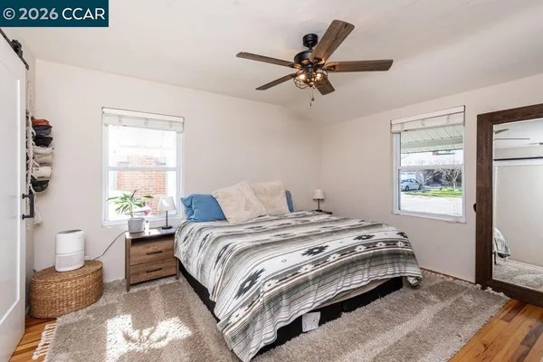 a bedroom with a bed a dresser and a window