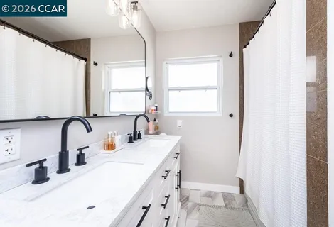 a bathroom with a double vanity sink window and