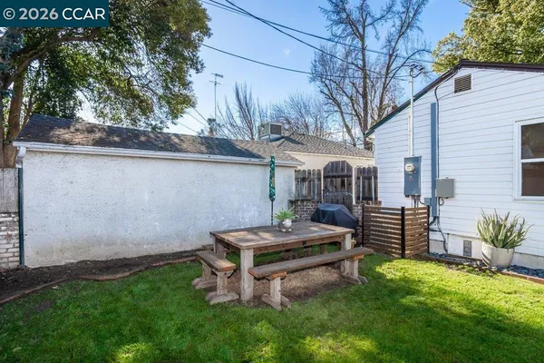 a view of a backyard with sitting area
