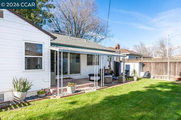 a view of a house with backyard sitting area and garden