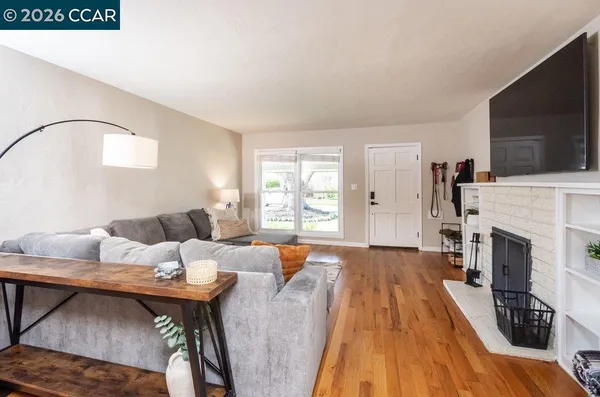 a living room with furniture fireplace and flat screen tv