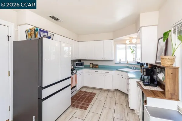 a kitchen with a refrigerator and a sink