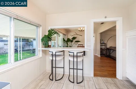 a dining room with furniture and window