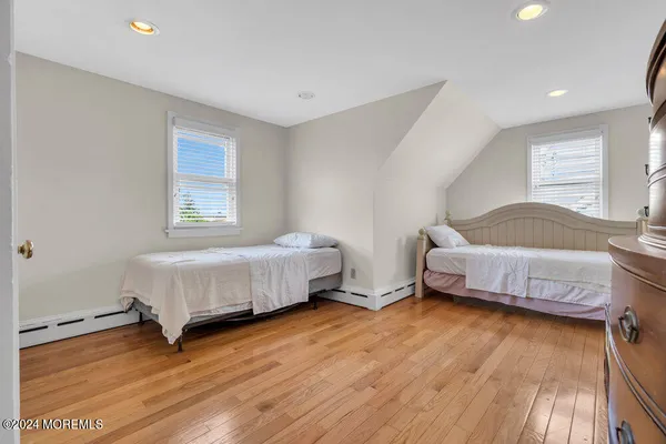 a bedroom with a bed and a wooden floor
