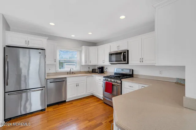 a kitchen with granite countertop stainless steel appliances and refrigerator