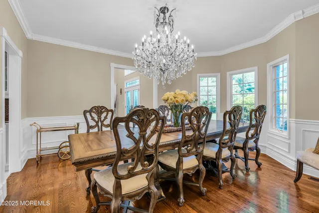 a view of a dining room with furniture and a chandelier