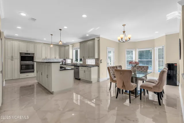 a kitchen with stainless steel appliances granite countertop a sink stove and cabinets