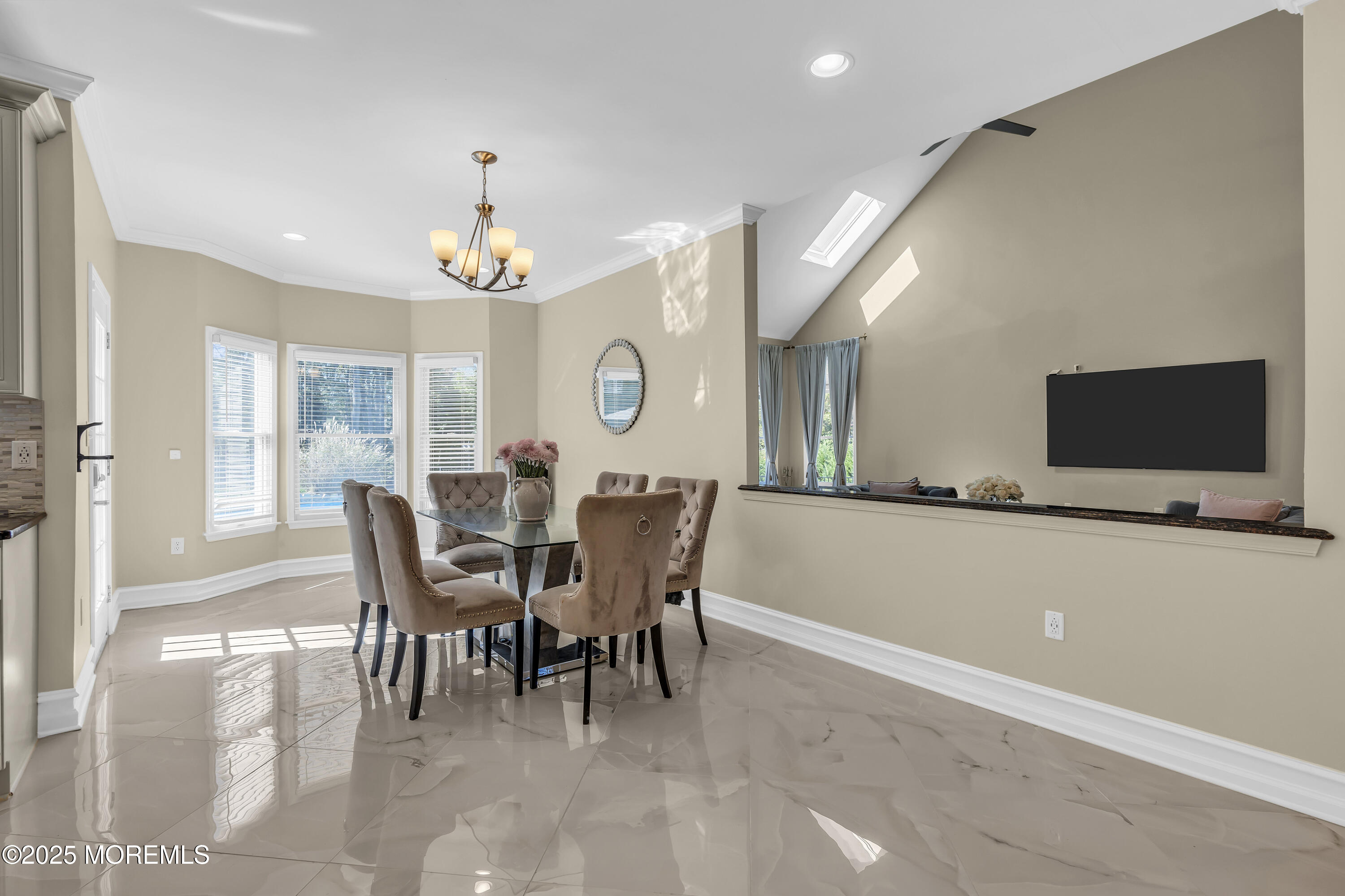 1 Fountayne Lane Manalapan, NJ 07726 - Photo 20 of 69 a view of a dining room with furniture and a chandelier