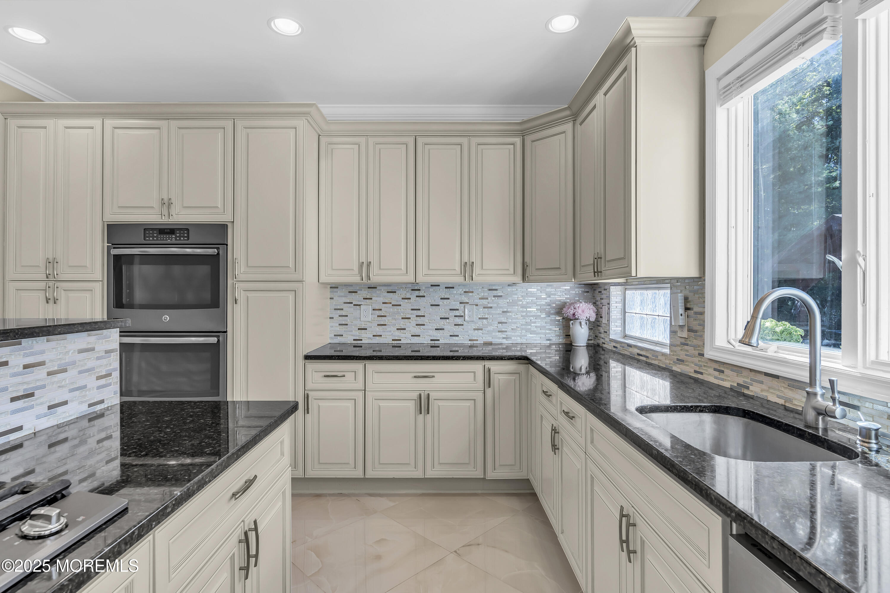 1 Fountayne Lane Manalapan, NJ 07726 - Photo 24 of 69 a kitchen with stainless steel appliances granite countertop a sink stove and cabinets