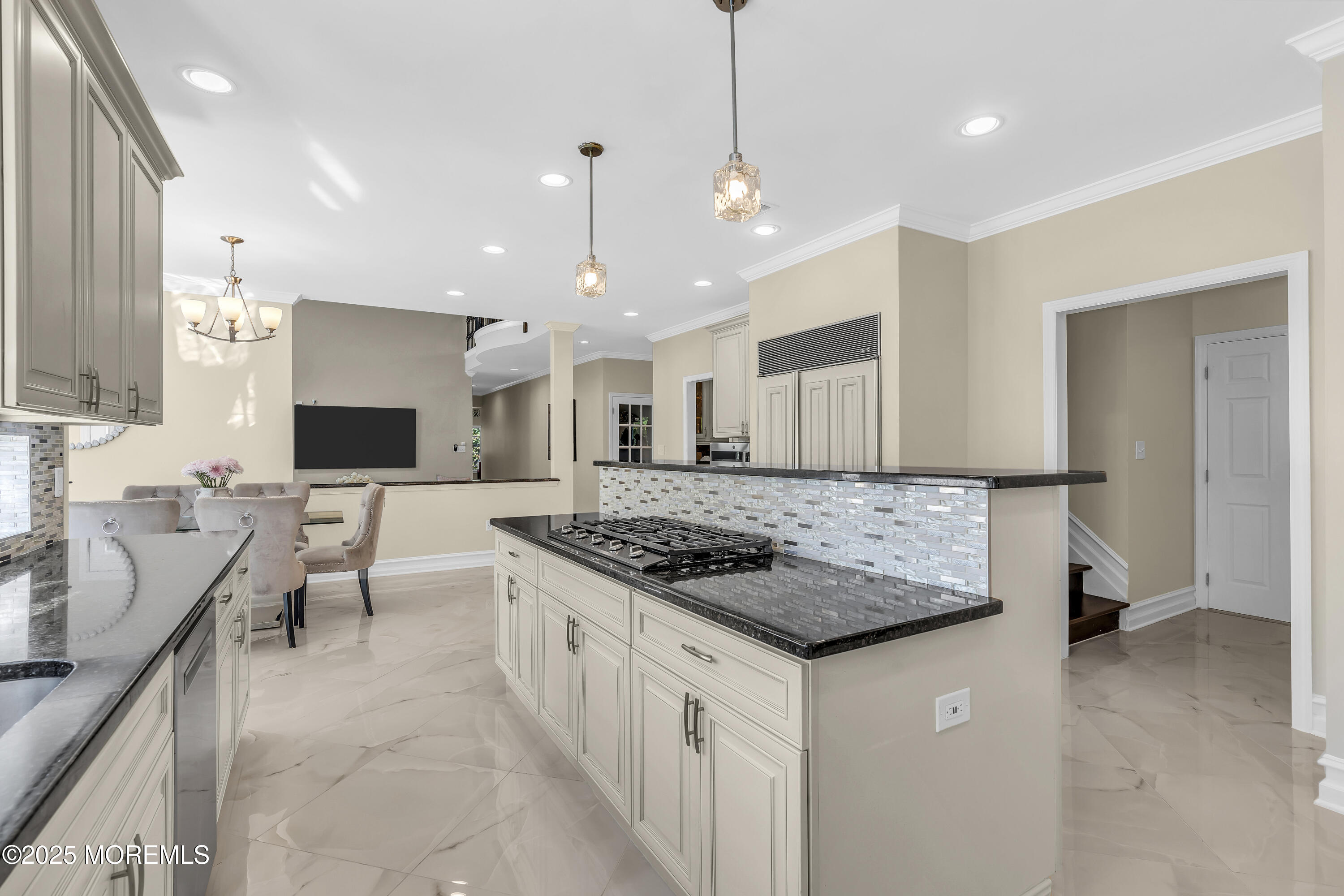 1 Fountayne Lane Manalapan, NJ 07726 - Photo 26 of 69 a large kitchen with kitchen island a sink a counter top space appliances and a living room view