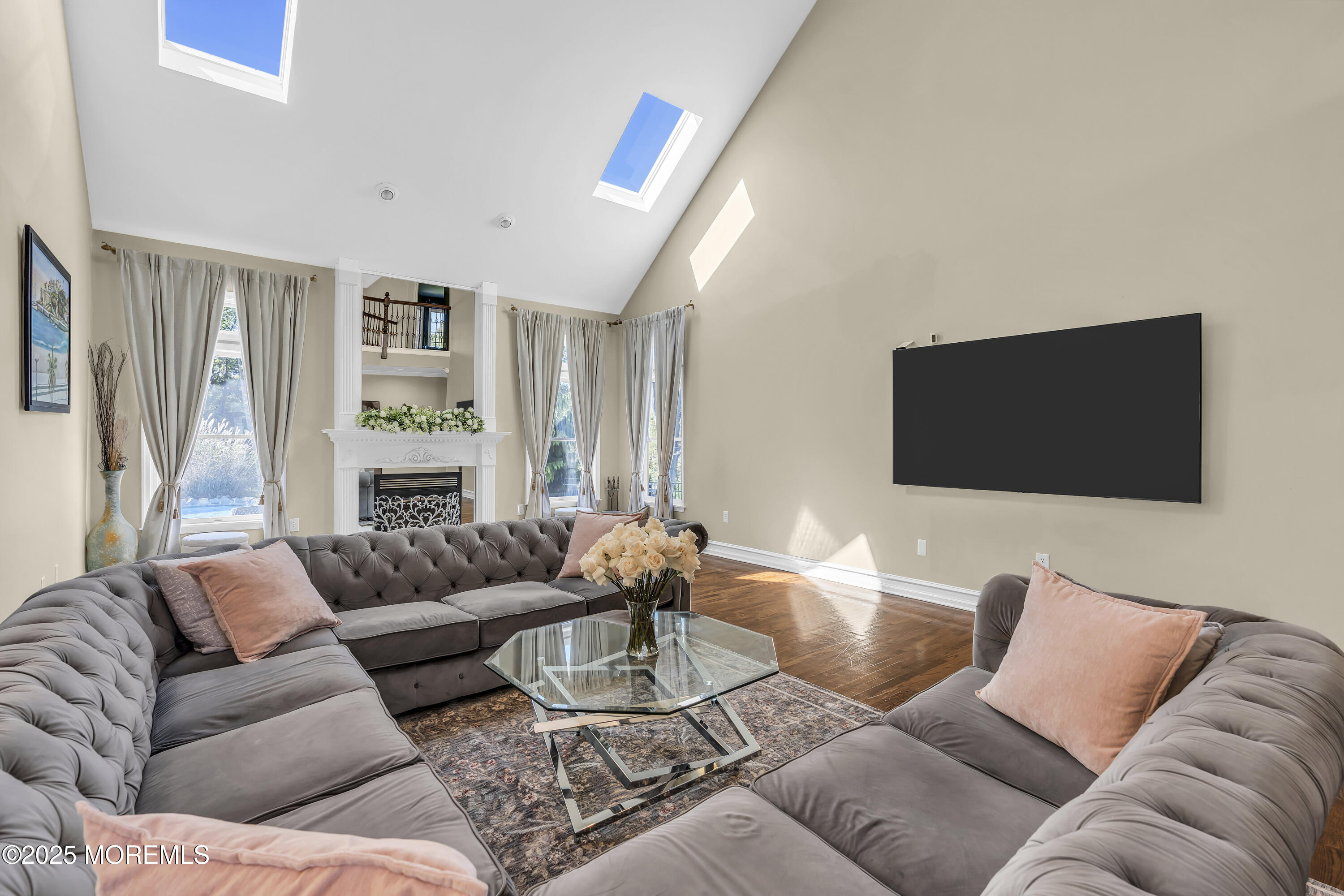 1 Fountayne Lane Manalapan, NJ 07726 - Photo 29 of 69 a living room with furniture and a flat screen tv