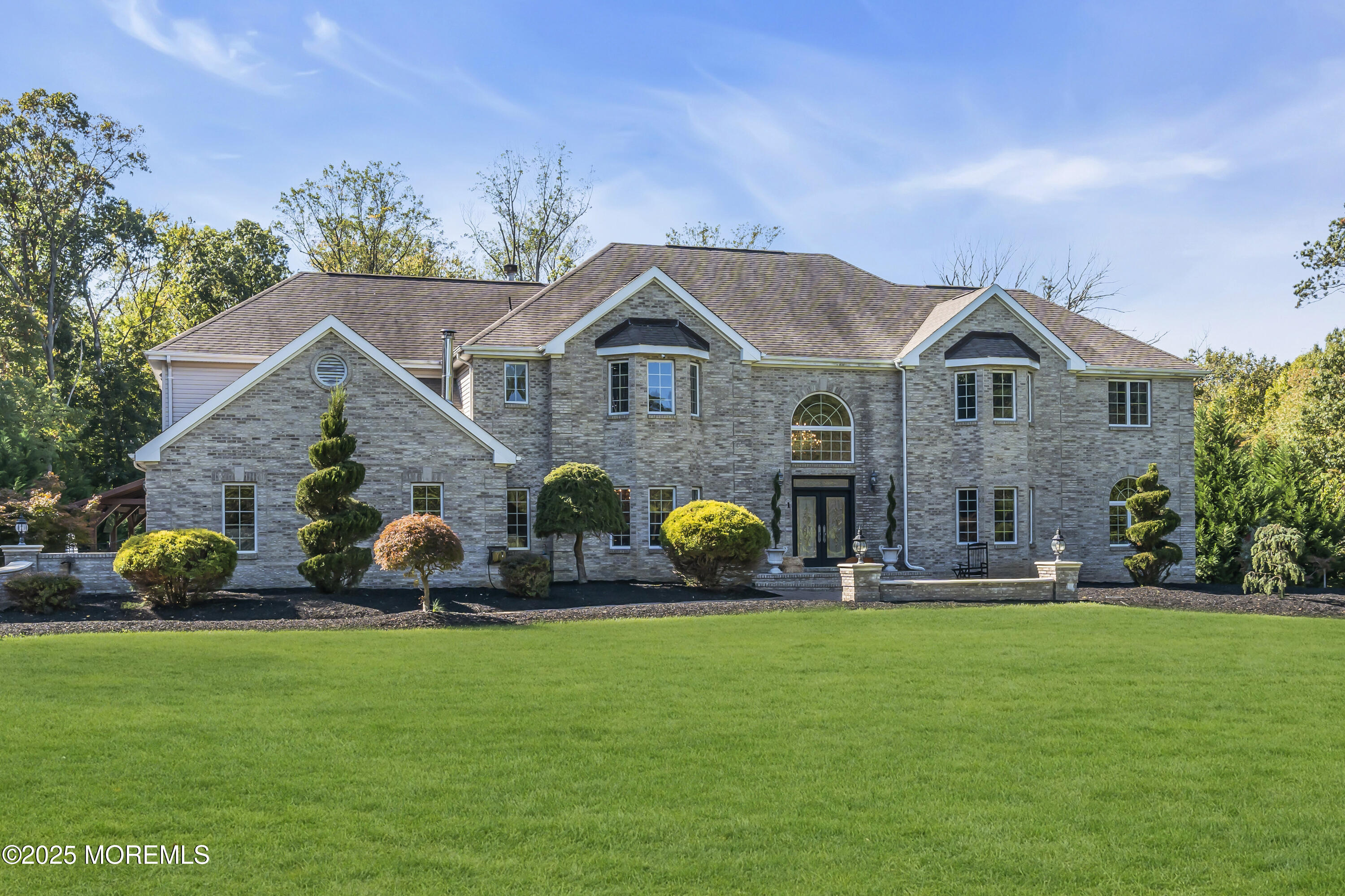 1 Fountayne Lane Manalapan, NJ 07726 - Photo 3 of 69 a front view of a house with garden