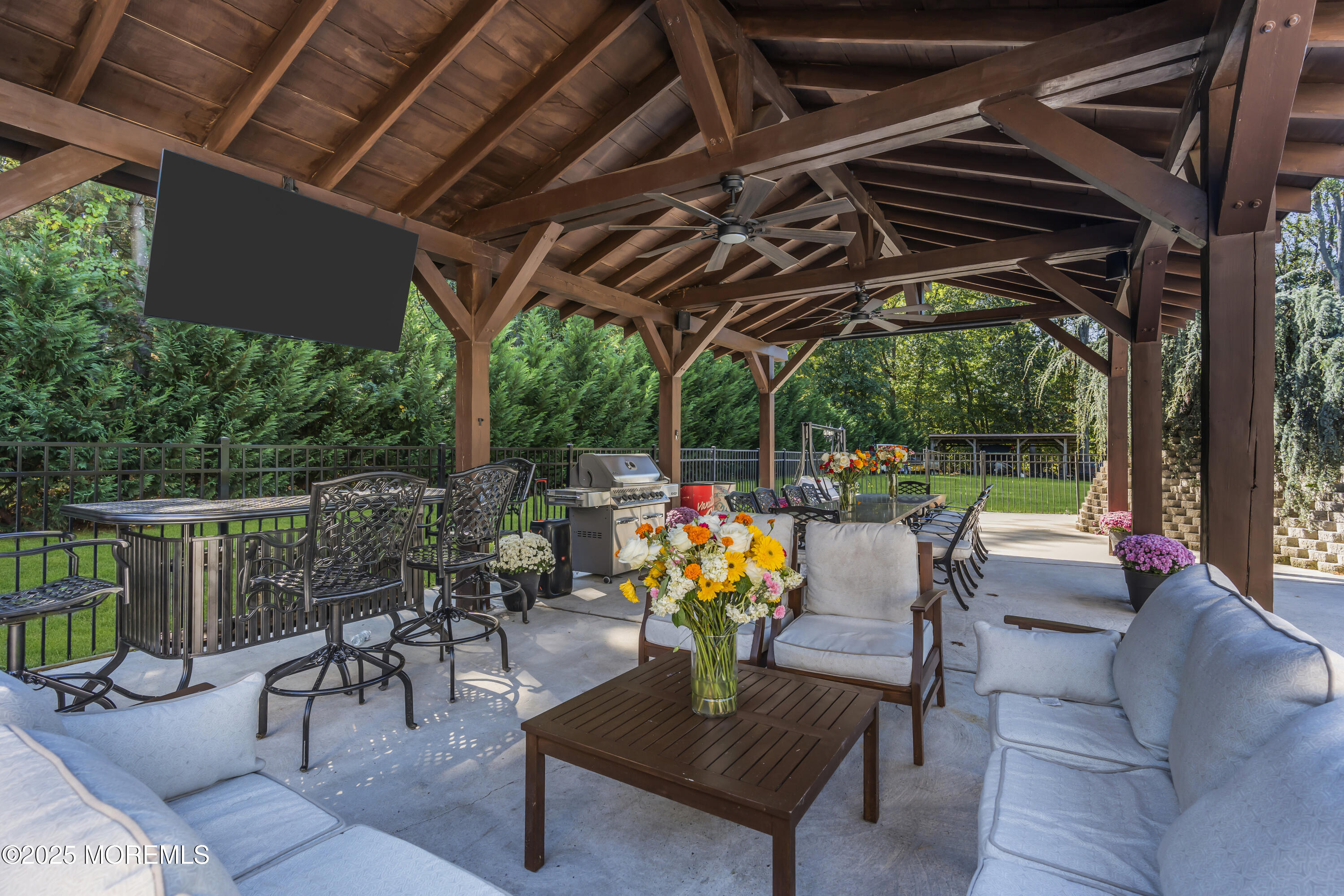 1 Fountayne Lane Manalapan, NJ 07726 - Photo 57 of 69 a view of a patio with couches chairs and a big yard