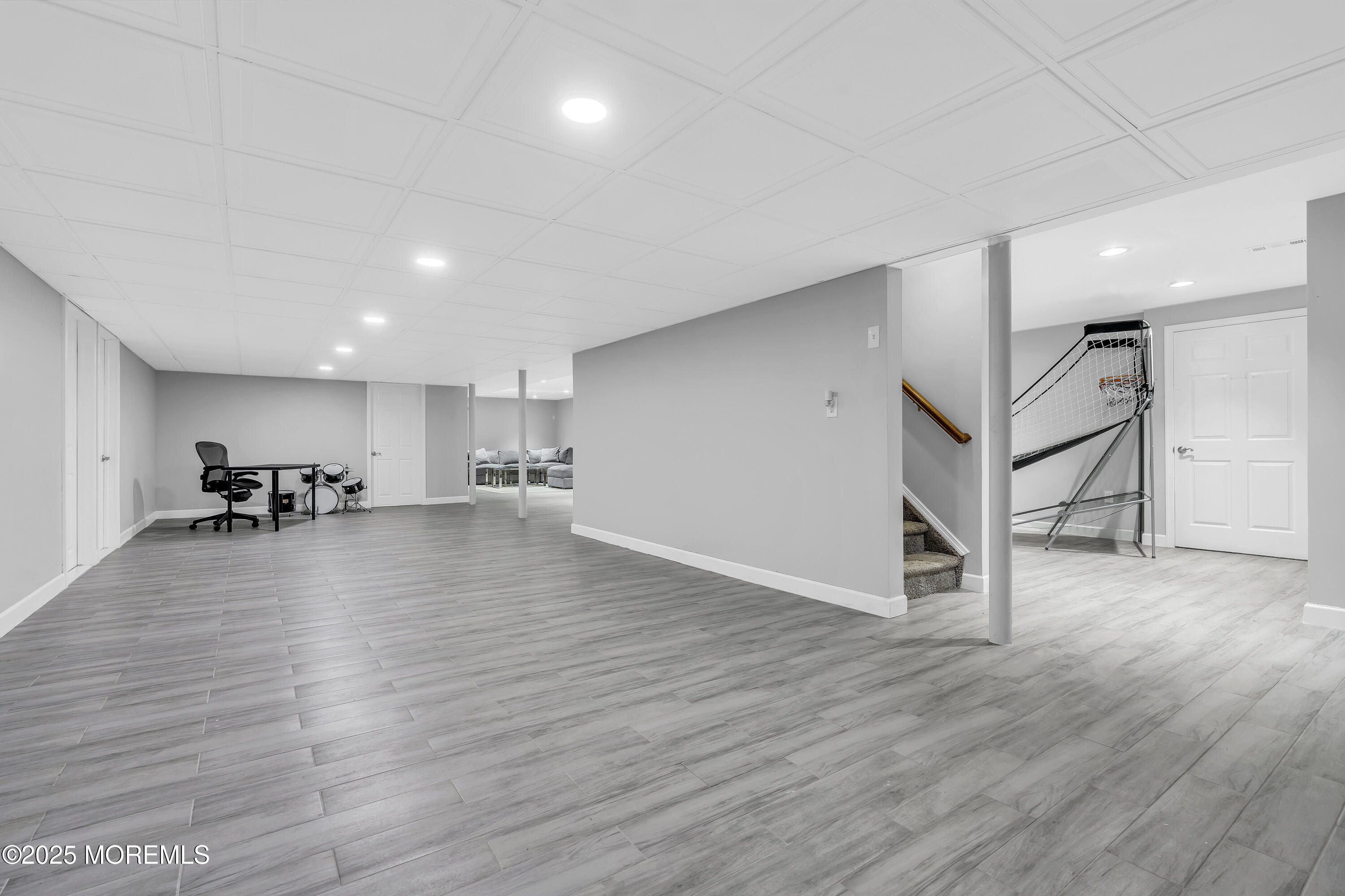 1 Fountayne Lane Manalapan, NJ 07726 - Photo 61 of 69 a view of an empty room and kitchen view with wooden floor