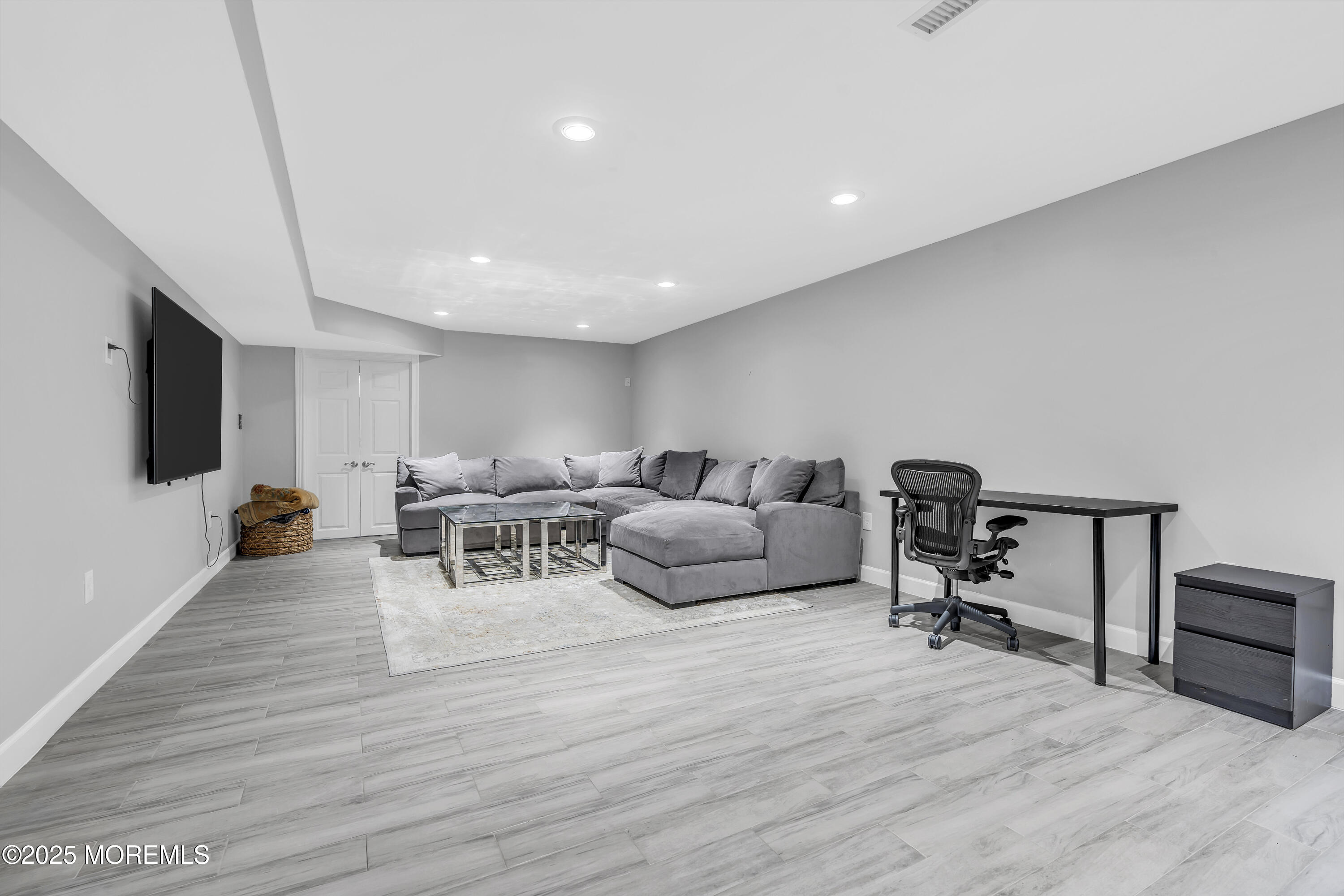 1 Fountayne Lane Manalapan, NJ 07726 - Photo 62 of 69 a living room with furniture and a flat screen tv