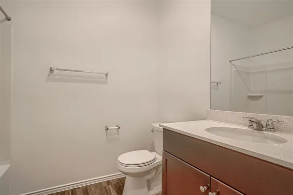 a bathroom with a sink a toilet and a mirror