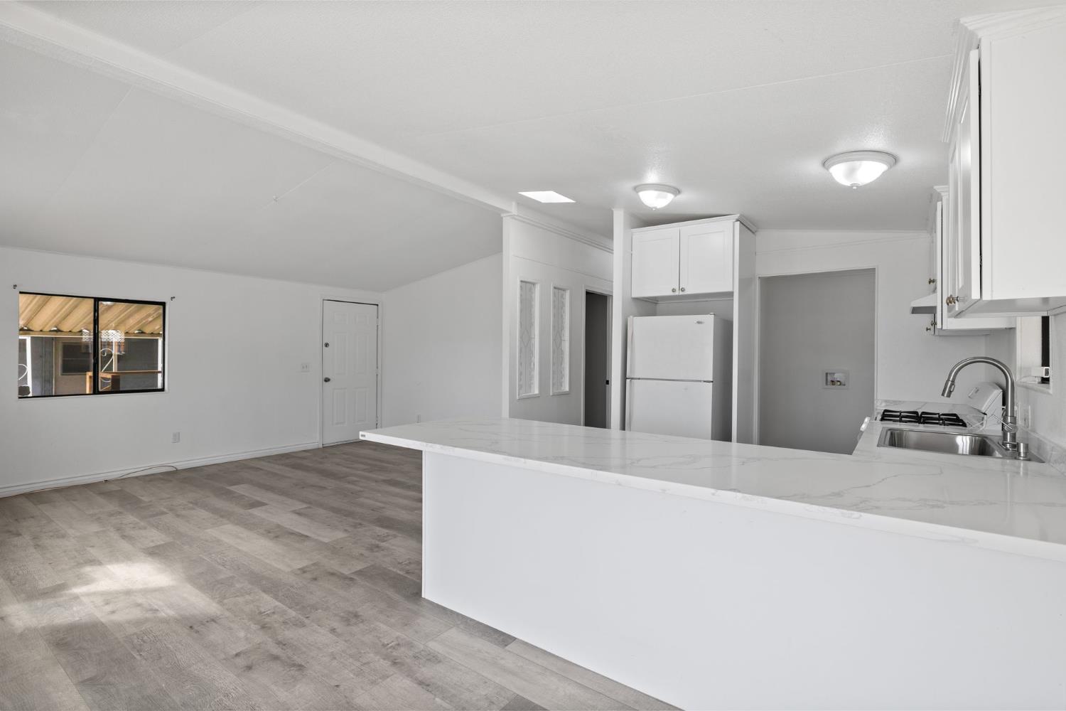 8300 Kern Canyon Road, Unit 156 Bakersfield, CA 93306 - Photo 13 of 40 a kitchen with stainless steel appliances a refrigerator and a sink