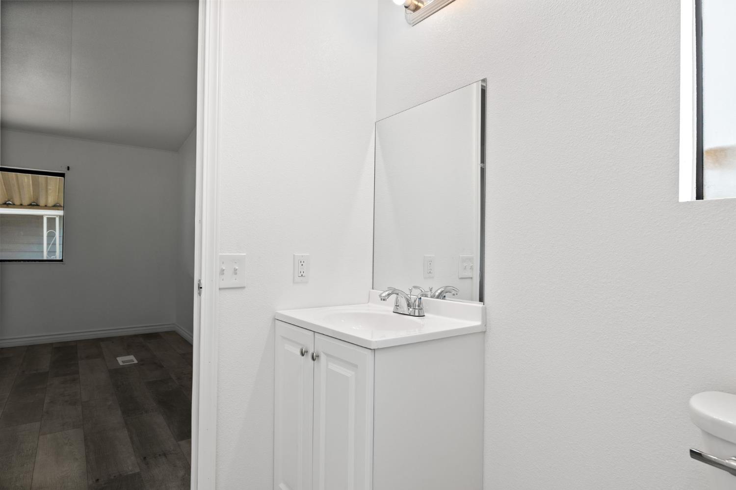 8300 Kern Canyon Road, Unit 156 Bakersfield, CA 93306 - Photo 22 of 40 a bathroom with a sink a toilet and mirror