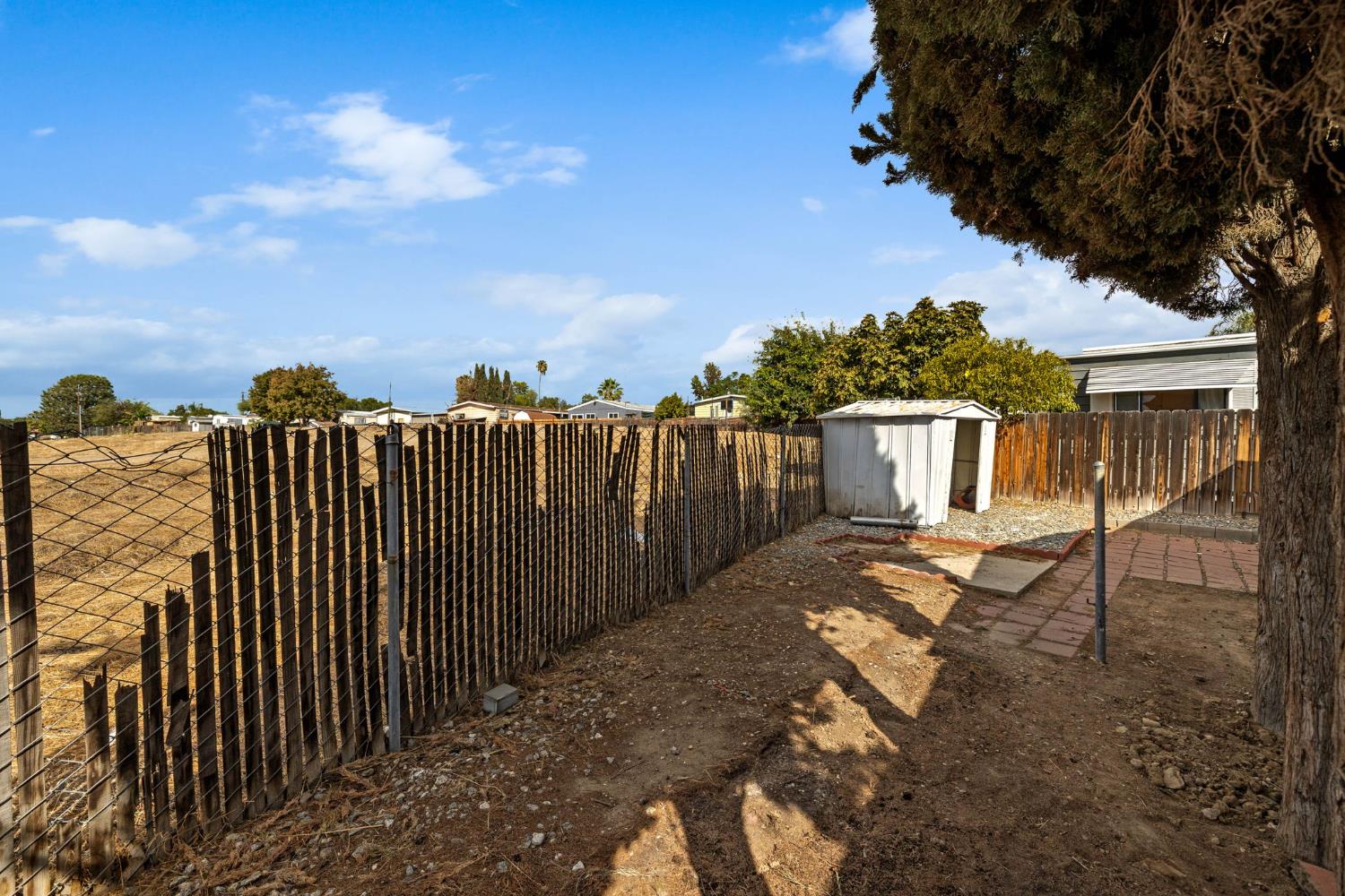 8300 Kern Canyon Road, Unit 156 Bakersfield, CA 93306 - Photo 28 of 40 a view of a backyard with wooden fence