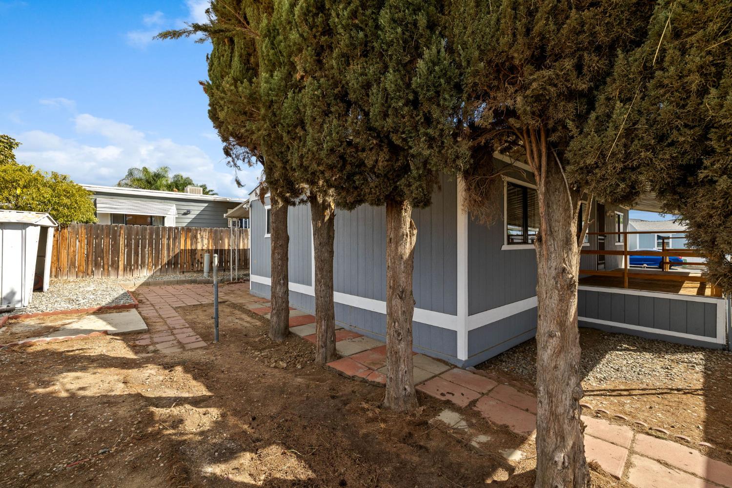 8300 Kern Canyon Road, Unit 156 Bakersfield, CA 93306 - Photo 29 of 40 a view of a house with backyard and a tree
