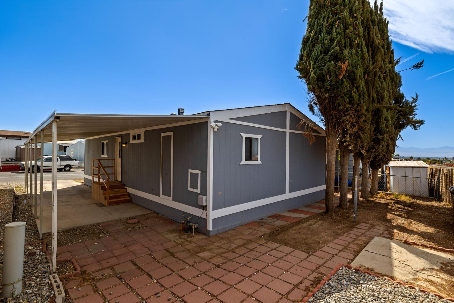 8300 Kern Canyon Road, Unit 156 Bakersfield, CA 93306 - Photo 31 of 40 a view of a house with backyard and sitting area
