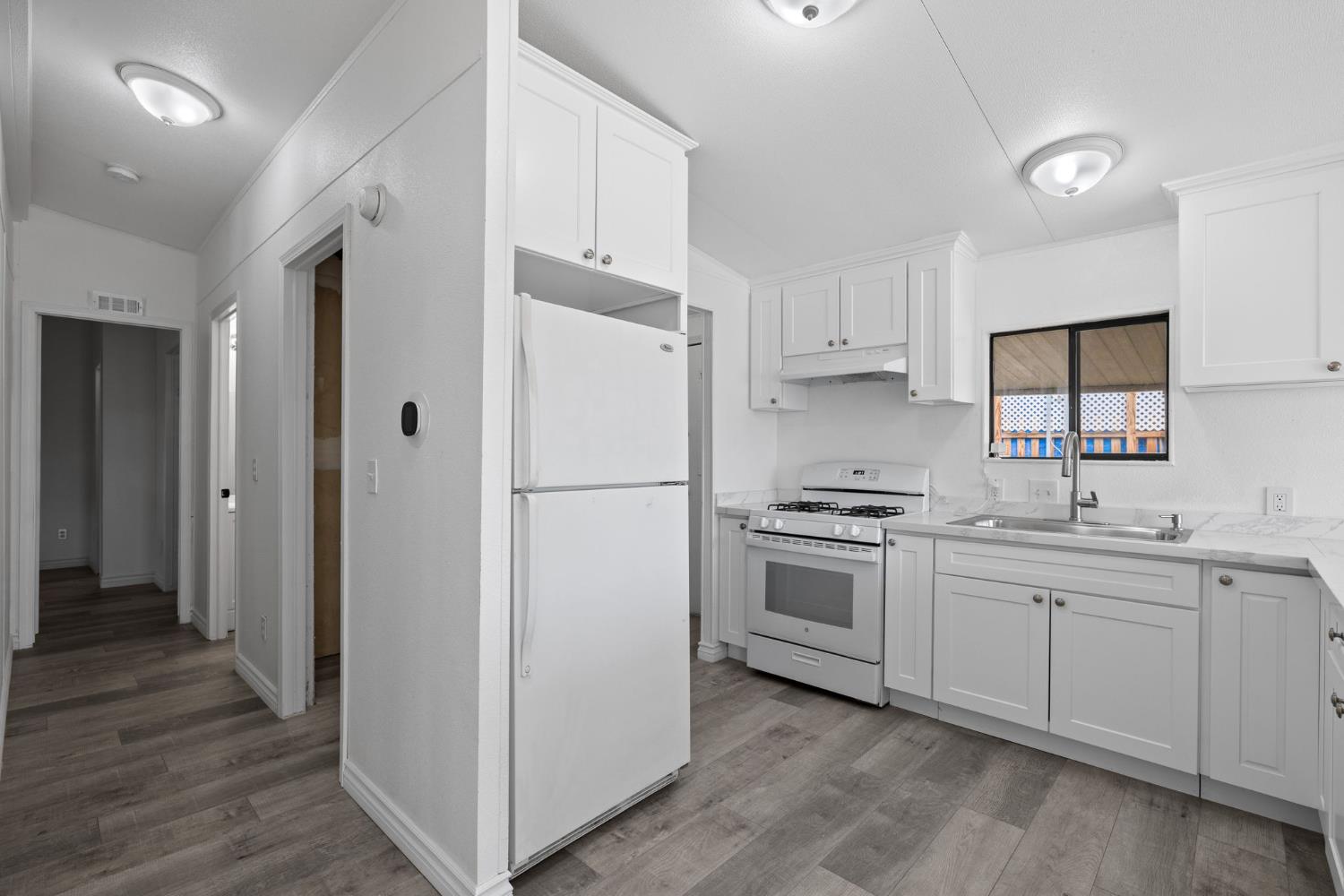 8300 Kern Canyon Road, Unit 156 Bakersfield, CA 93306 - Photo 33 of 40 a kitchen with cabinets and white stainless steel appliances