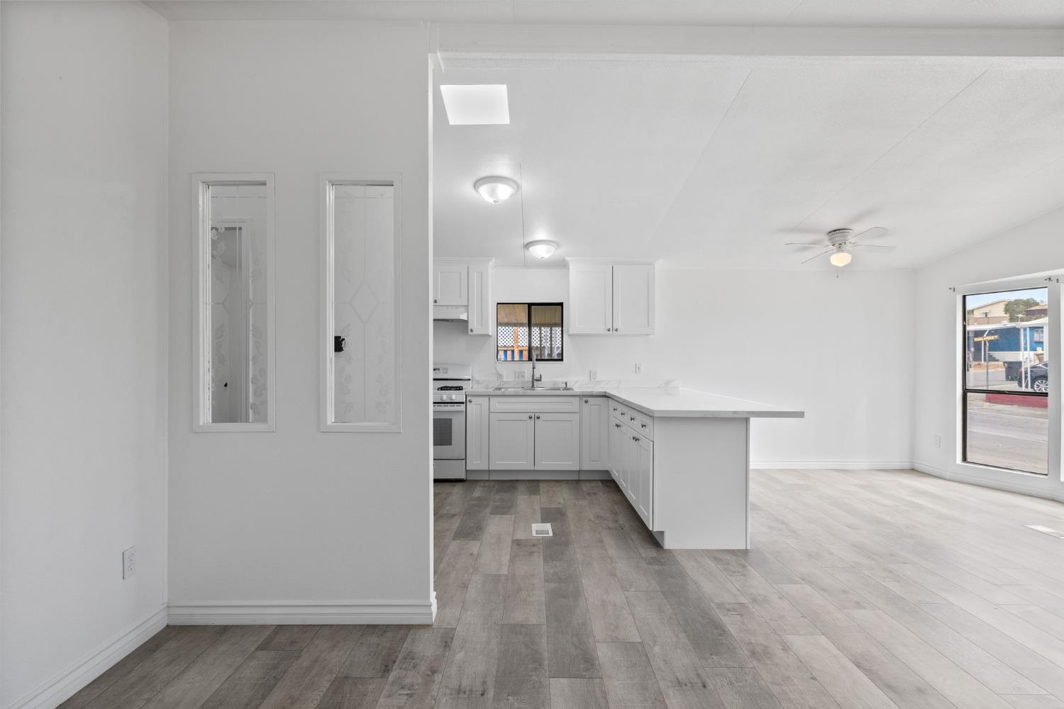 8300 Kern Canyon Road, Unit 156 Bakersfield, CA 93306 - Photo 34 of 40 a kitchen with white cabinets and window