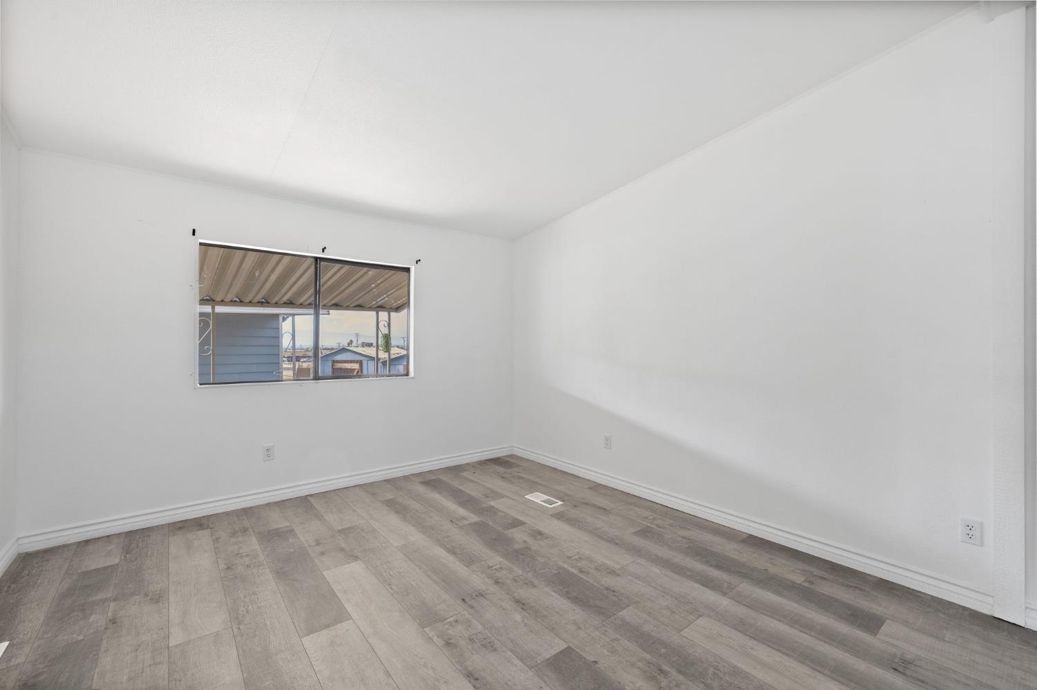 8300 Kern Canyon Road, Unit 156 Bakersfield, CA 93306 - Photo 38 of 40 an empty room with a empty space and window