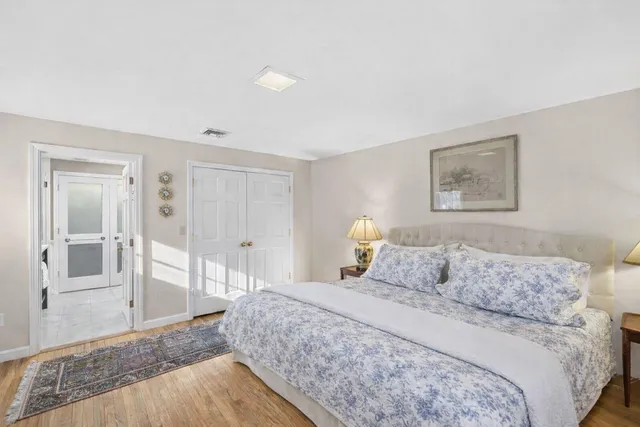 a bedroom with a bed and a chair