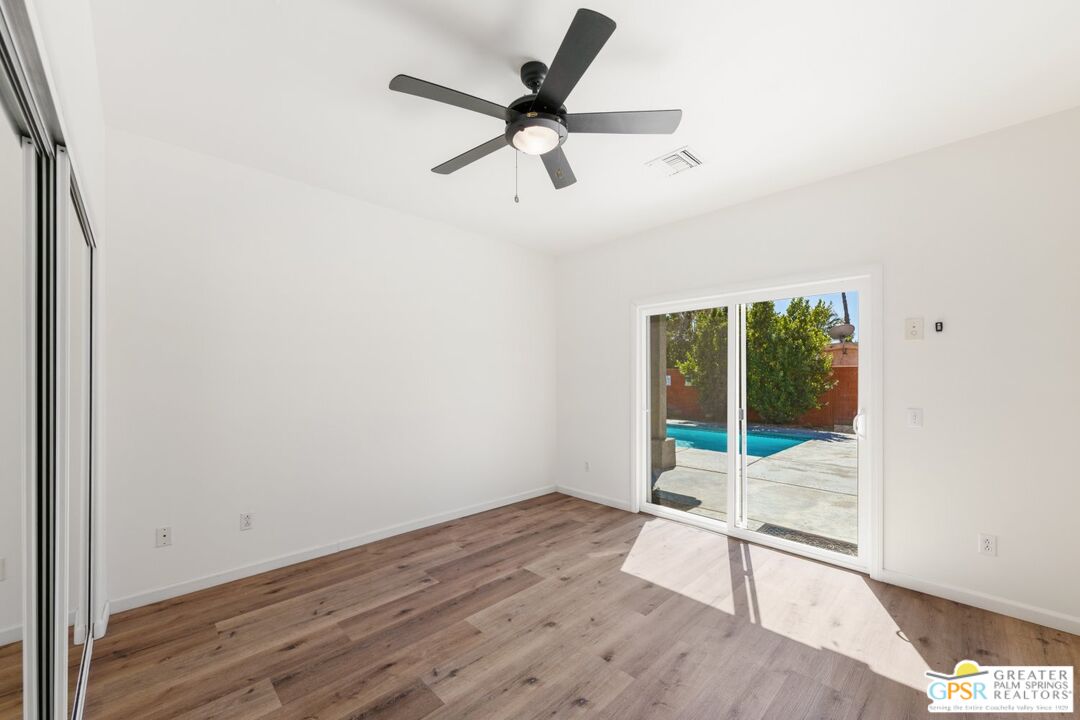 2885 East Sandia Road Palm Springs, CA 92262 - Photo 12 of 30 an empty room with wooden floor and windows