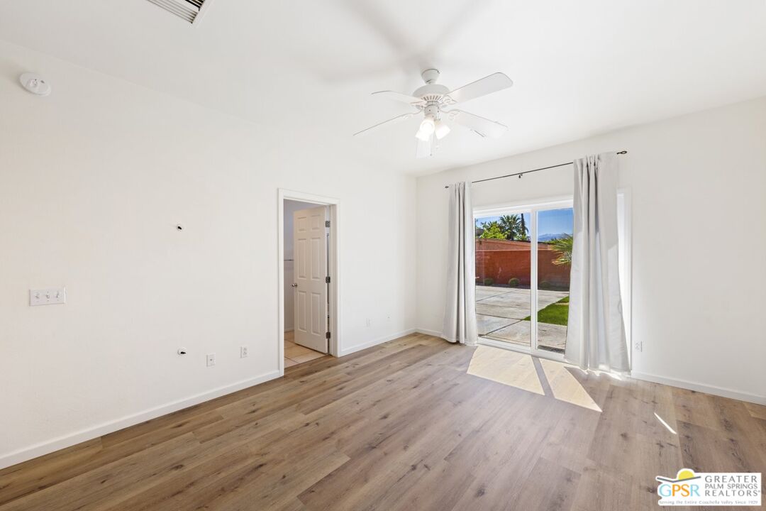 2885 East Sandia Road Palm Springs, CA 92262 - Photo 15 of 30 a view of an empty room with wooden floor and a window