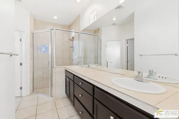 a bathroom with a double vanity sink mirror and double