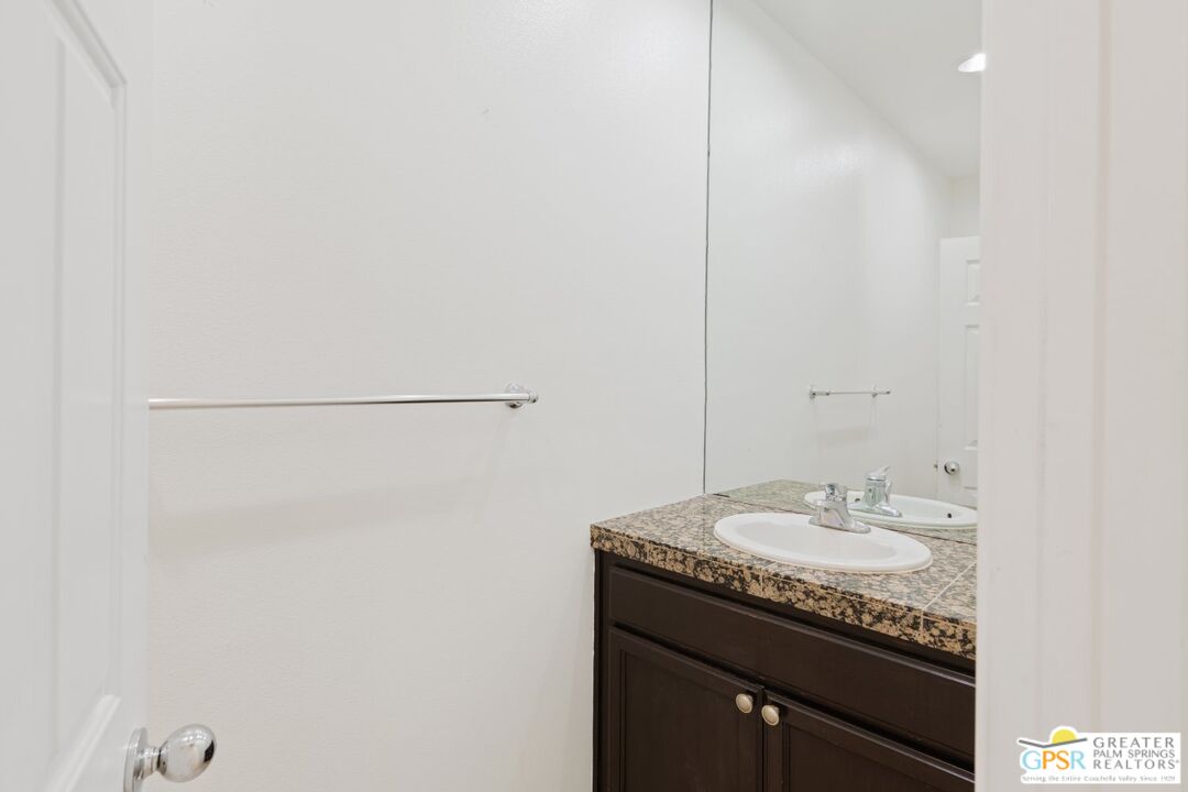 2885 East Sandia Road Palm Springs, CA 92262 - Photo 18 of 30 a bathroom with a granite countertop sink and a mirror