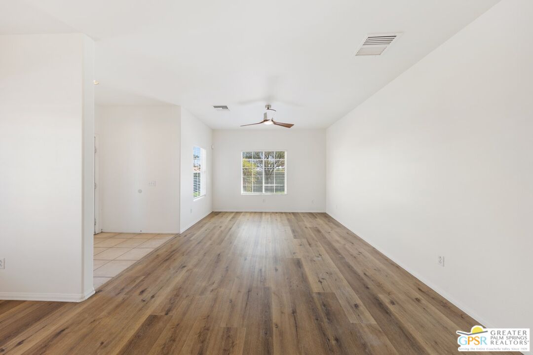 2885 East Sandia Road Palm Springs, CA 92262 - Photo 21 of 30 an empty room with wooden floor windows and ceiling fan