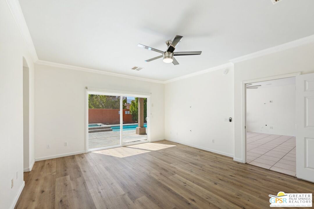 2885 East Sandia Road Palm Springs, CA 92262 - Photo 23 of 30 an empty room with wooden floor and windows