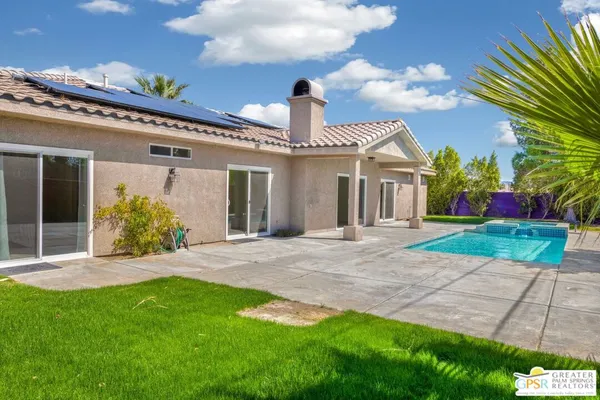a front view of a house with a garden and plants