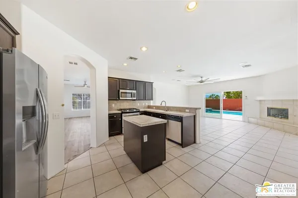 a kitchen with stainless steel appliances granite countertop a refrigerator and a stove