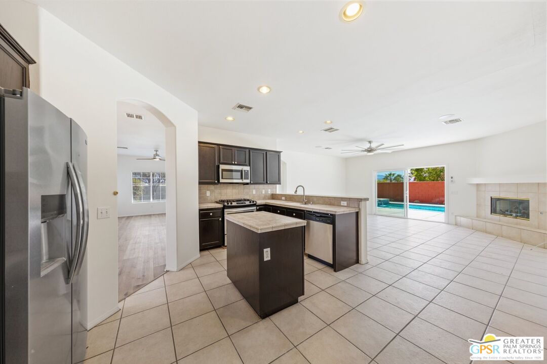 2885 East Sandia Road Palm Springs, CA 92262 - Photo 7 of 30 a kitchen with stainless steel appliances granite countertop a refrigerator and a stove