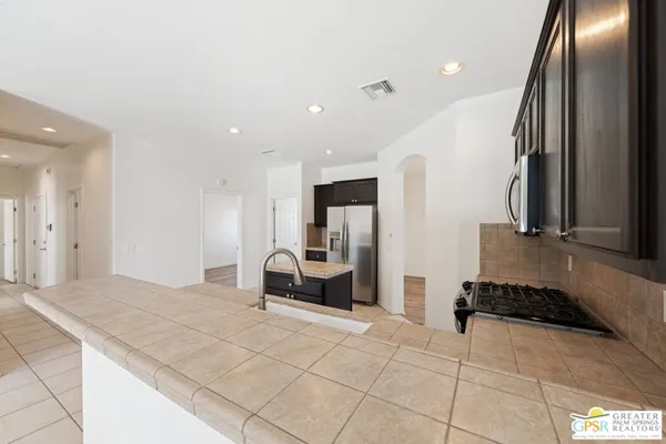 a large bedroom with a large bed and furniture