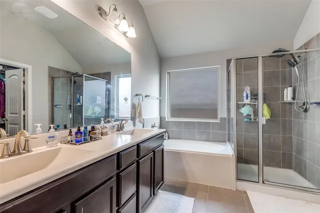a bathroom with a double vanity sink mirror double and shower