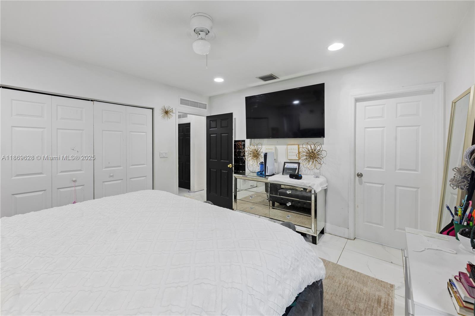 135 Northwest 6th Avenue Dania Beach, FL 33004 - Photo 8 of 26 a bedroom with a bed and a flat screen tv