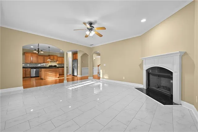 a view of an empty room with a fireplace and chandelier